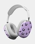 Angled side view of the Cosmic Giggles AirPods Max Case, featuring a lavender background with playful black crescent patterns, designed for a chic and unique look.